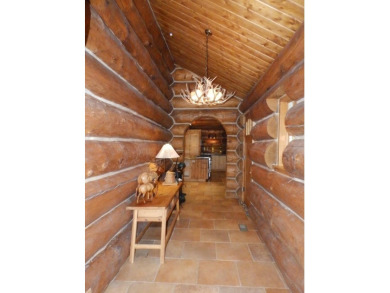 This stunning log home located on the 6th tee of Garland's on Garland Resort and Golf Club  in Michigan - for sale on GolfHomes.com, golf home, golf lot