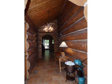 This stunning log home located on the 6th tee of Garland's on Garland Resort and Golf Club  in Michigan - for sale on GolfHomes.com, golf home, golf lot