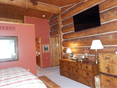 This stunning log home located on the 6th tee of Garland's on Garland Resort and Golf Club  in Michigan - for sale on GolfHomes.com, golf home, golf lot