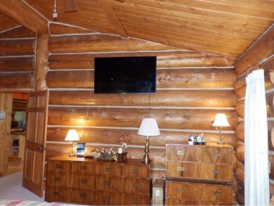 This stunning log home located on the 6th tee of Garland's on Garland Resort and Golf Club  in Michigan - for sale on GolfHomes.com, golf home, golf lot