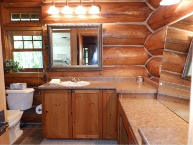 This stunning log home located on the 6th tee of Garland's on Garland Resort and Golf Club  in Michigan - for sale on GolfHomes.com, golf home, golf lot