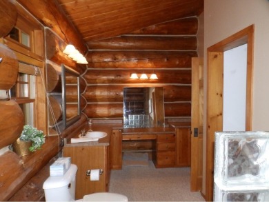 This stunning log home located on the 6th tee of Garland's on Garland Resort and Golf Club  in Michigan - for sale on GolfHomes.com, golf home, golf lot