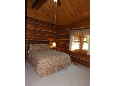 This stunning log home located on the 6th tee of Garland's on Garland Resort and Golf Club  in Michigan - for sale on GolfHomes.com, golf home, golf lot