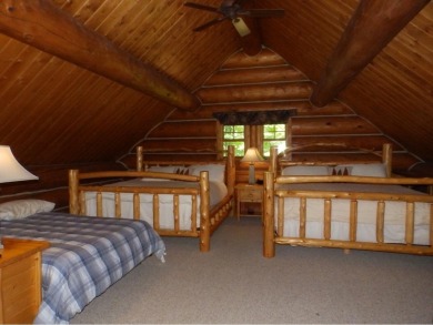 This stunning log home located on the 6th tee of Garland's on Garland Resort and Golf Club  in Michigan - for sale on GolfHomes.com, golf home, golf lot