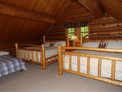 This stunning log home located on the 6th tee of Garland's on Garland Resort and Golf Club  in Michigan - for sale on GolfHomes.com, golf home, golf lot