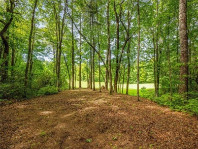 Located off Cherokee Point, this private .915-acre homesite on Lake Toxaway Country Club in North Carolina - for sale on GolfHomes.com, golf home, golf lot