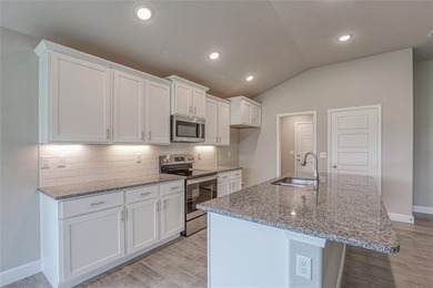 This traditional ranch-style new home is complemented by a on Heritage Park Golf Course in Kansas - for sale on GolfHomes.com, golf home, golf lot