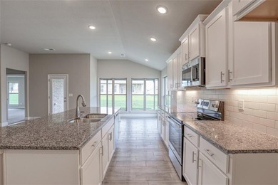 This traditional ranch-style new home is complemented by a on Heritage Park Golf Course in Kansas - for sale on GolfHomes.com, golf home, golf lot