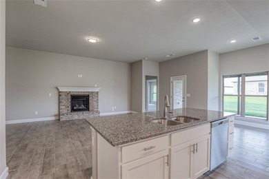 This traditional ranch-style new home is complemented by a on Heritage Park Golf Course in Kansas - for sale on GolfHomes.com, golf home, golf lot