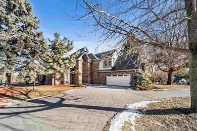 Situated on over a half-acre double lot among mature trees and on Brown Deer Golf Club in Iowa - for sale on GolfHomes.com, golf home, golf lot