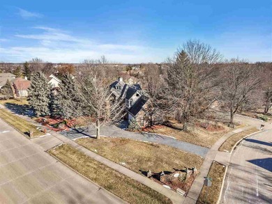 Situated on over a half-acre double lot among mature trees and on Brown Deer Golf Club in Iowa - for sale on GolfHomes.com, golf home, golf lot