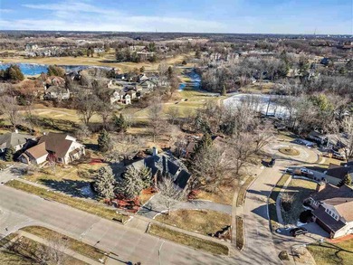 Situated on over a half-acre double lot among mature trees and on Brown Deer Golf Club in Iowa - for sale on GolfHomes.com, golf home, golf lot