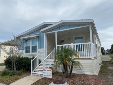 THIS 2018 CHAMPION HOME OFFERS ALL THE LUXURY MUST HAVES on Silver Dollar Golf and Trap Club in Florida - for sale on GolfHomes.com, golf home, golf lot
