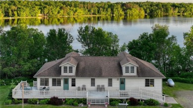 Discover this exquisite waterfront property situated on the on Barker Lake Country Club in Wisconsin - for sale on GolfHomes.com, golf home, golf lot