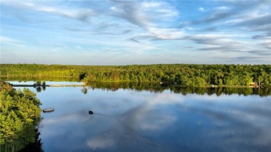 Discover this exquisite waterfront property situated on the on Barker Lake Country Club in Wisconsin - for sale on GolfHomes.com, golf home, golf lot