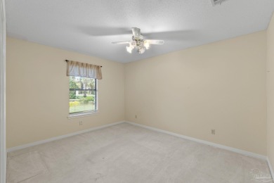 Charming Gulf Breeze brick home nestled in a picturesque setting on Tiger Point Golf and Country Club in Florida - for sale on GolfHomes.com, golf home, golf lot