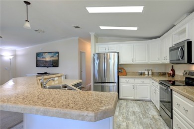 Enjoy direct golf course and water views from this beautifully on Barefoot Bay Golf Course in Florida - for sale on GolfHomes.com, golf home, golf lot