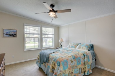 Enjoy direct golf course and water views from this beautifully on Barefoot Bay Golf Course in Florida - for sale on GolfHomes.com, golf home, golf lot