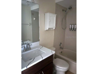 A solid two-story 4 bed/ 2.5 bath, 2 car garage, pool home is on Northdale Golf and Tennis Club in Florida - for sale on GolfHomes.com, golf home, golf lot