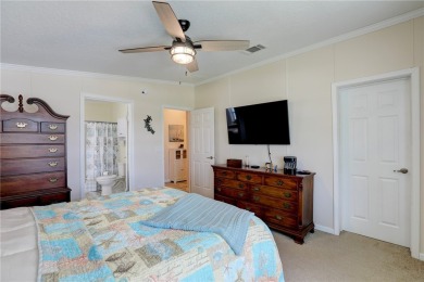 Enjoy direct golf course and water views from this beautifully on Barefoot Bay Golf Course in Florida - for sale on GolfHomes.com, golf home, golf lot
