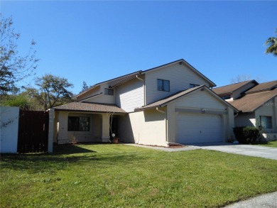 A solid two-story 4 bed/ 2.5 bath, 2 car garage, pool home is on Northdale Golf and Tennis Club in Florida - for sale on GolfHomes.com, golf home, golf lot