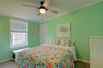 Enjoy direct golf course and water views from this beautifully on Barefoot Bay Golf Course in Florida - for sale on GolfHomes.com, golf home, golf lot