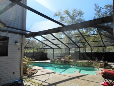 A solid two-story 4 bed/ 2.5 bath, 2 car garage, pool home is on Northdale Golf and Tennis Club in Florida - for sale on GolfHomes.com, golf home, golf lot
