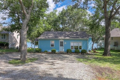 This quaint and charming LAKEFRONT bungalow offers a peaceful on Linn Valley Lakes - Deer Trace Golf Course in Kansas - for sale on GolfHomes.com, golf home, golf lot