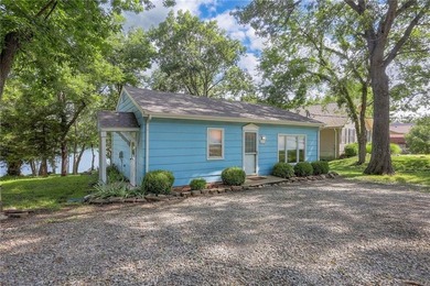 This quaint and charming LAKEFRONT bungalow offers a peaceful on Linn Valley Lakes - Deer Trace Golf Course in Kansas - for sale on GolfHomes.com, golf home, golf lot