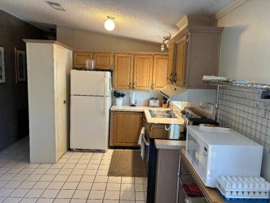 Unique home in Del Tura (55 and over community on leased land) on Del Tura Golf and Country Club in Florida - for sale on GolfHomes.com, golf home, golf lot