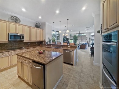 PRIVATE LAKESIDE RETREAT - This updated 5 BR, 6 bath, 4 garage on The Cape Club of Palm City in Florida - for sale on GolfHomes.com, golf home, golf lot