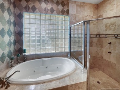 PRIVATE LAKESIDE RETREAT - This updated 5 BR, 6 bath, 4 garage on The Cape Club of Palm City in Florida - for sale on GolfHomes.com, golf home, golf lot