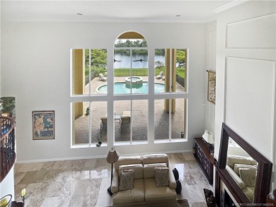 PRIVATE LAKESIDE RETREAT - This updated 5 BR, 6 bath, 4 garage on The Cape Club of Palm City in Florida - for sale on GolfHomes.com, golf home, golf lot