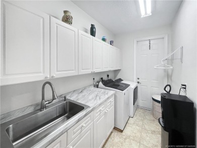 PRIVATE LAKESIDE RETREAT - This updated 5 BR, 6 bath, 4 garage on The Cape Club of Palm City in Florida - for sale on GolfHomes.com, golf home, golf lot