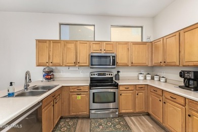 This beautifully maintained 5-bedroom, 3-bath home features a on Augusta Ranch Golf Club in Arizona - for sale on GolfHomes.com, golf home, golf lot