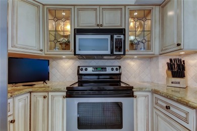 Perched on the top corner of the building, this 2-bedroom on Isla Del Sol Yacht and Country Club in Florida - for sale on GolfHomes.com, golf home, golf lot