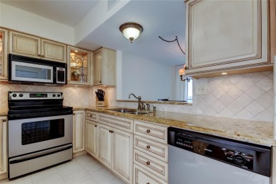 Perched on the top corner of the building, this 2-bedroom on Isla Del Sol Yacht and Country Club in Florida - for sale on GolfHomes.com, golf home, golf lot
