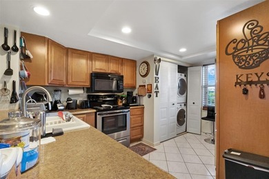 Beautifully updated top floor condo in the 55+ community of Palm on Oriole Golf and Tennis Club in Florida - for sale on GolfHomes.com, golf home, golf lot