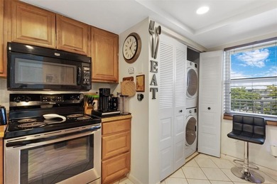 Beautifully updated top floor condo in the 55+ community of Palm on Oriole Golf and Tennis Club in Florida - for sale on GolfHomes.com, golf home, golf lot