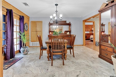 This stunning Satterwhite log home offers 2,550 square feet of on Hide-A-Way Lake Golf Course in Texas - for sale on GolfHomes.com, golf home, golf lot