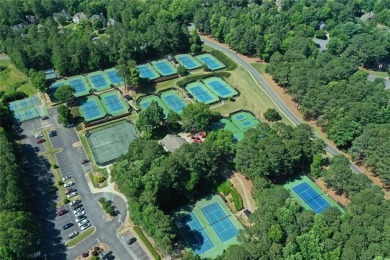 Experience refined living at 1010 Graystone Crossing, nestled in on The Golf Club of Georgia in Georgia - for sale on GolfHomes.com, golf home, golf lot