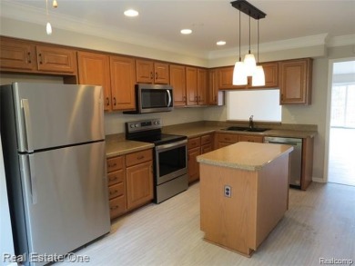 Welcome to this beautiful end unit condo in Country Club Village on Bushwood Golf Club in Michigan - for sale on GolfHomes.com, golf home, golf lot