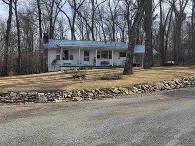 This is a must-see home with 3 bedrooms and 1 and a 1/2 baths on Cherokee Village North Course in Arkansas - for sale on GolfHomes.com, golf home, golf lot