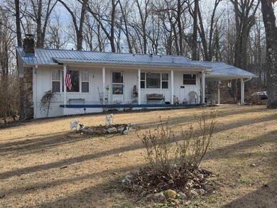 This is a must-see home with 3 bedrooms and 1 and a 1/2 baths on Cherokee Village North Course in Arkansas - for sale on GolfHomes.com, golf home, golf lot