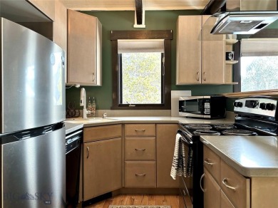 Charming and well-maintained end-unit condo featuring a cozy on Big Sky of Montana Golf Course in Montana - for sale on GolfHomes.com, golf home, golf lot