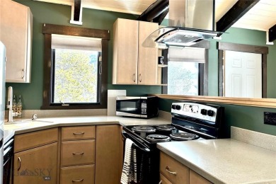 Charming and well-maintained end-unit condo featuring a cozy on Big Sky of Montana Golf Course in Montana - for sale on GolfHomes.com, golf home, golf lot