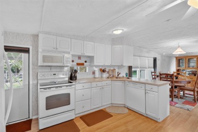 THIS CHARMING 2-bedroom, 2-bath mobile home is nestled in the on Bay Tree Golf Course in Florida - for sale on GolfHomes.com, golf home, golf lot