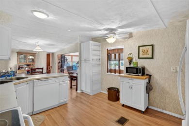 THIS CHARMING 2-bedroom, 2-bath mobile home is nestled in the on Bay Tree Golf Course in Florida - for sale on GolfHomes.com, golf home, golf lot