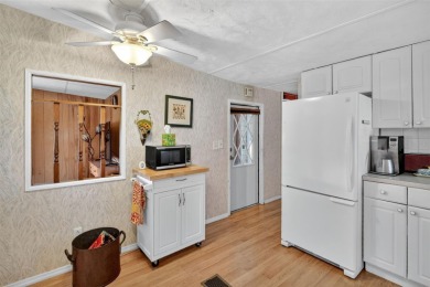 THIS CHARMING 2-bedroom, 2-bath mobile home is nestled in the on Bay Tree Golf Course in Florida - for sale on GolfHomes.com, golf home, golf lot