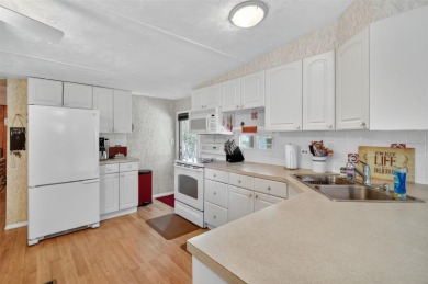 THIS CHARMING 2-bedroom, 2-bath mobile home is nestled in the on Bay Tree Golf Course in Florida - for sale on GolfHomes.com, golf home, golf lot